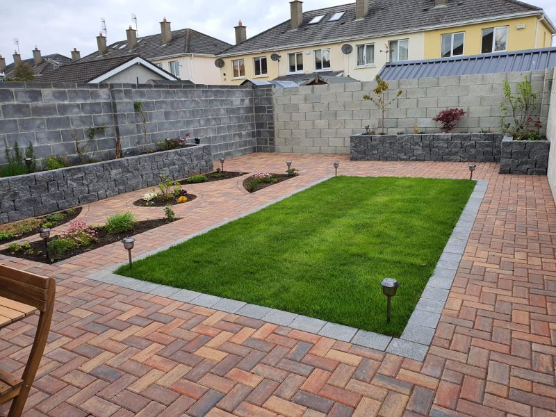 A completed cobblelock patio and fresh lawn in a Dublin back garden