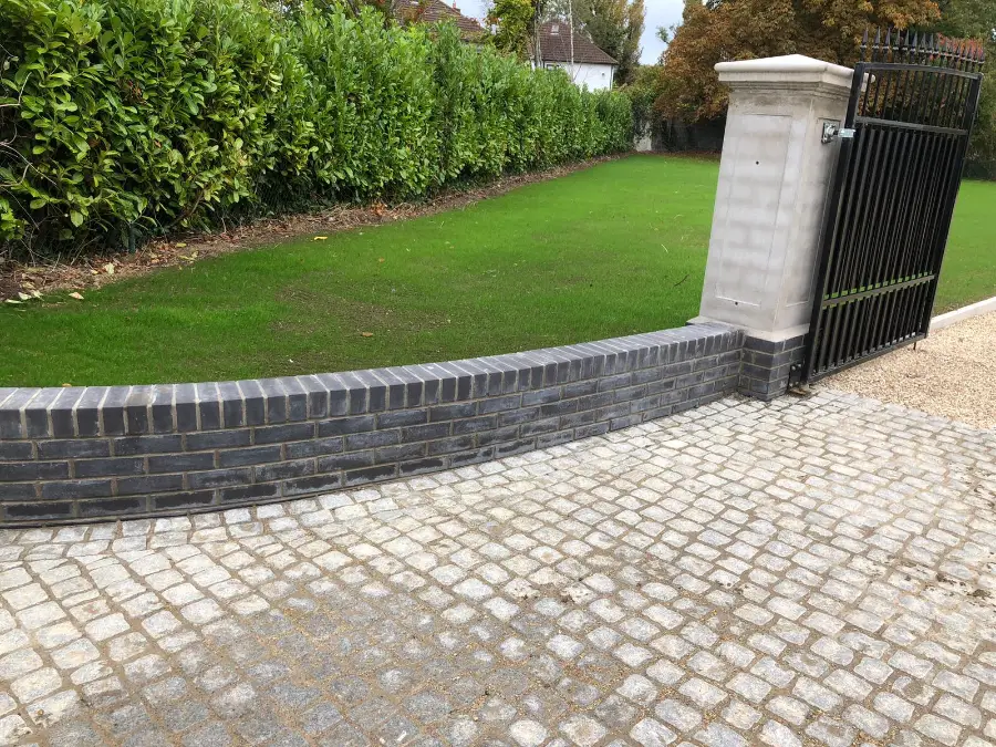 A cobblestone entrance driveway with granite kerbing edging a lawn in Dublin